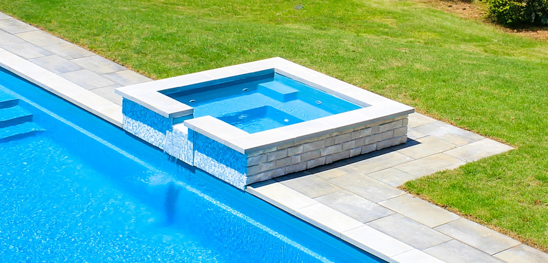 The Haven with Overflow - a freestanding spa with waterfall into fibreglass pool