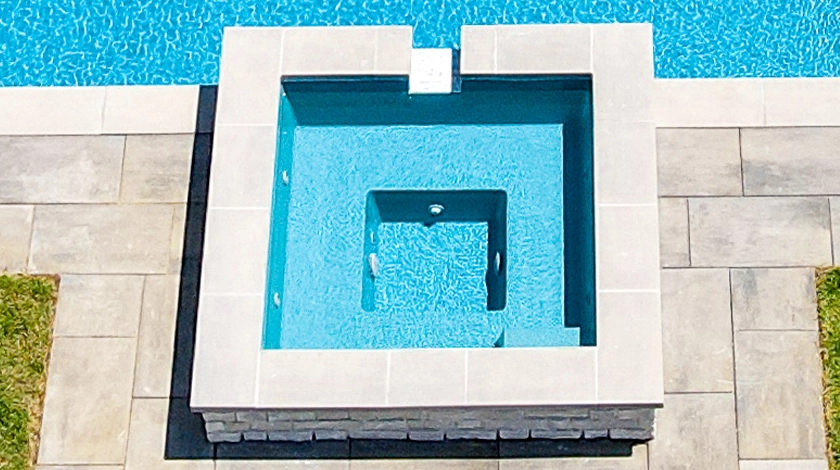 The Haven with Overflow - a freestanding spa with waterfall into fibreglass pool