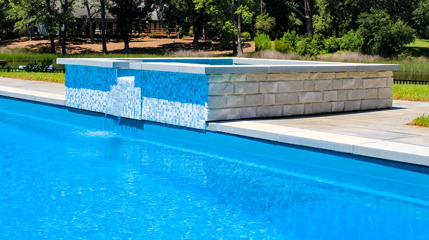 The Haven with Overflow - a freestanding spa with waterfall into fibreglass pool