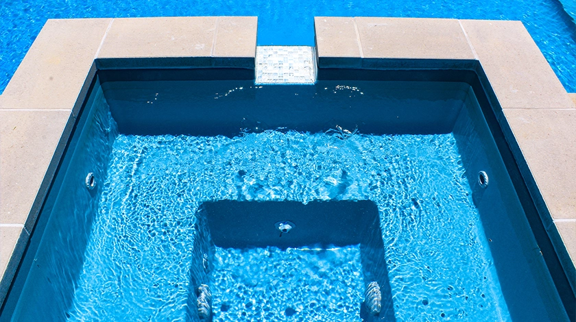 The Haven with Overflow - a freestanding spa with waterfall into fibreglass pool