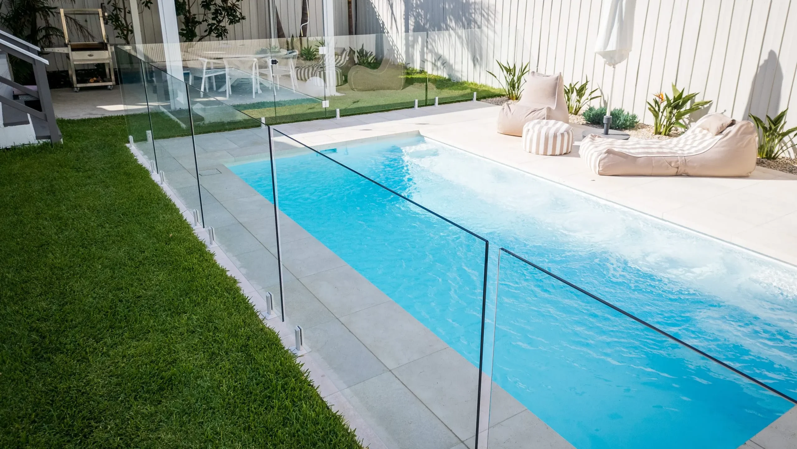 Reminder: Stock up on essential pool maintenance supplies before storm or cyclone season, including pool shock, algaecide, water-testing kits, and suitable cleaning tools such as a pool brush and leaf rake. Having these supplies ready will make post-cyclone cleaning easier and help you remove debris, address potential water contamination, and restore balanced water chemistry in your fibreglass pool. Always follow product instructions and check that your pool equipment is safe to operate before resuming maintenance. Pool with storm clouds